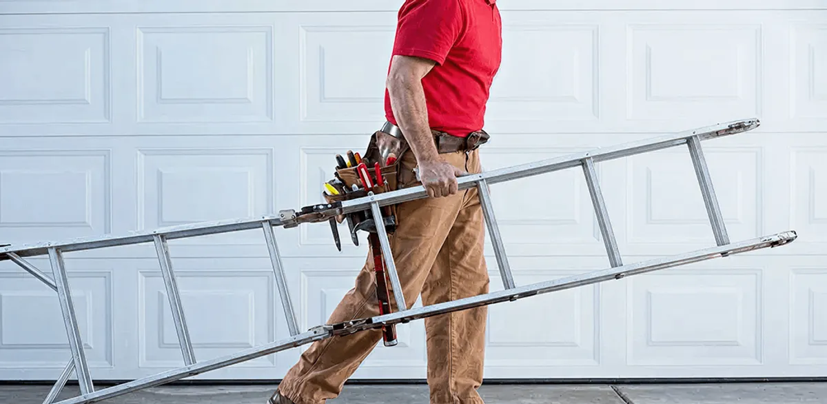 Garage door repair technician arriving with tools and ladder in Nashua, NH