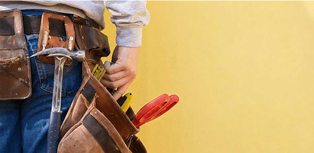 Handyman with tool belt ready for home repairs and maintenance in Nashua, NH